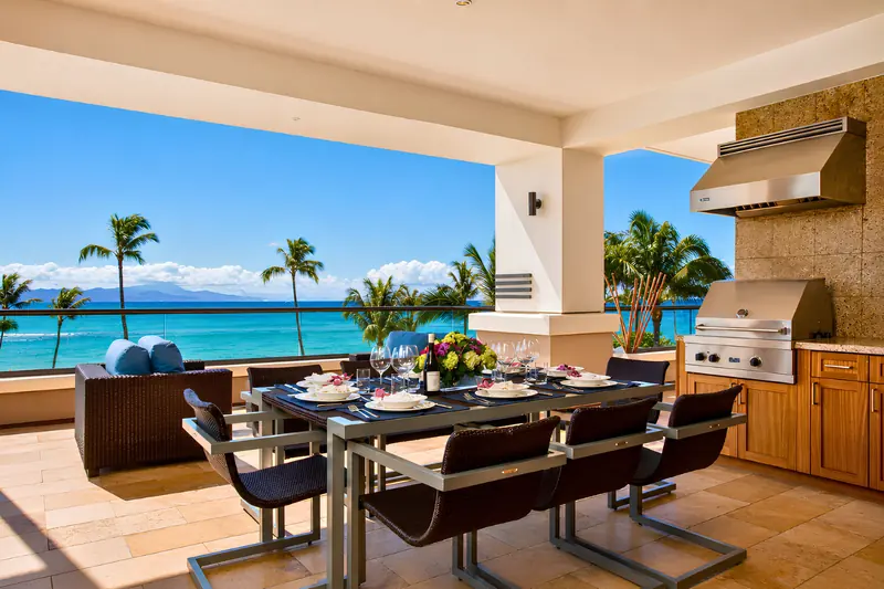 Oceanfront lanai dining table with a grill and ocean views at Honua Kai on Maui