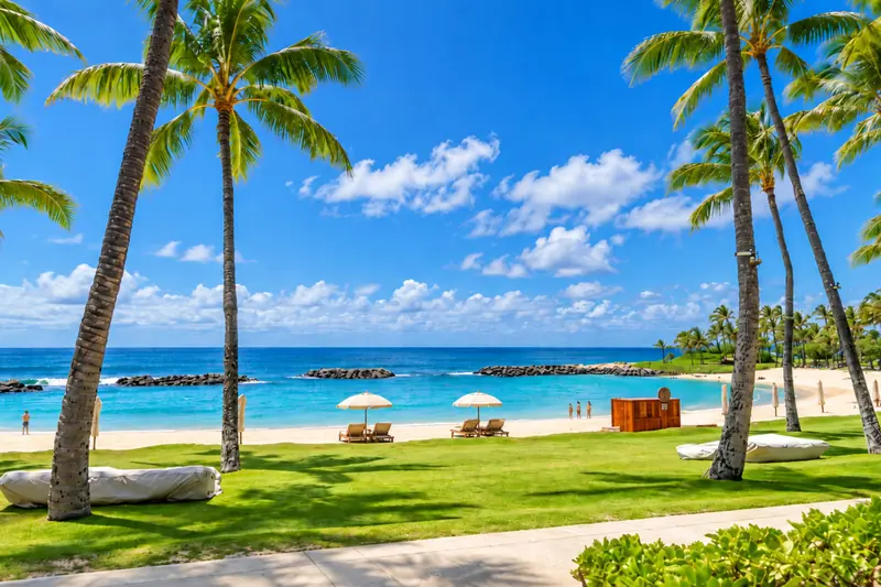 Palm-lined lawn and sandy lagoon beach at Ko Olina on Oahu